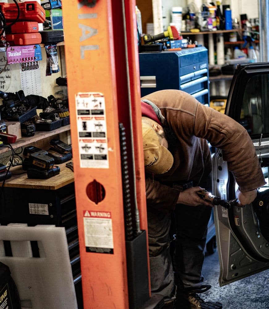 Mechanic working on a car door