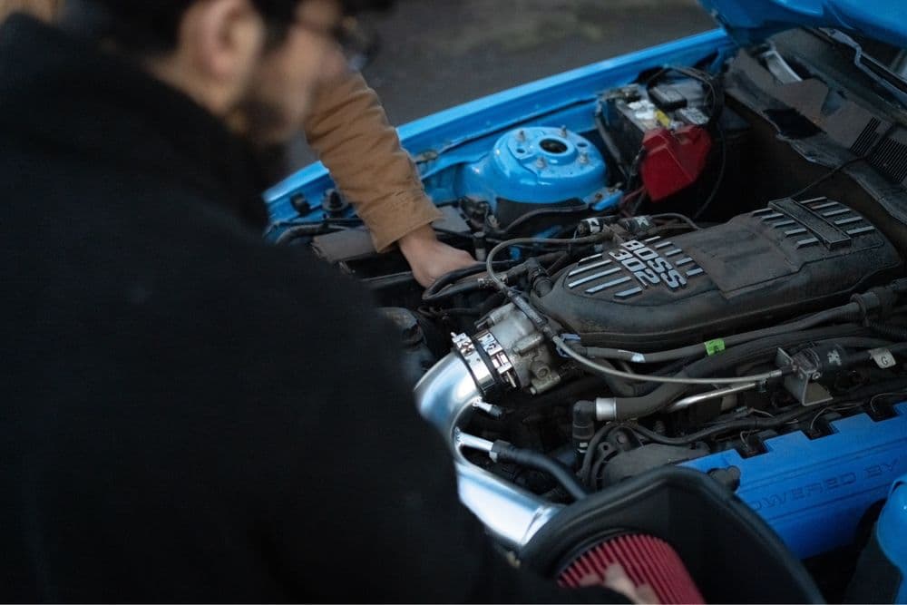 K&H AutoShop — mechanic working on an engine